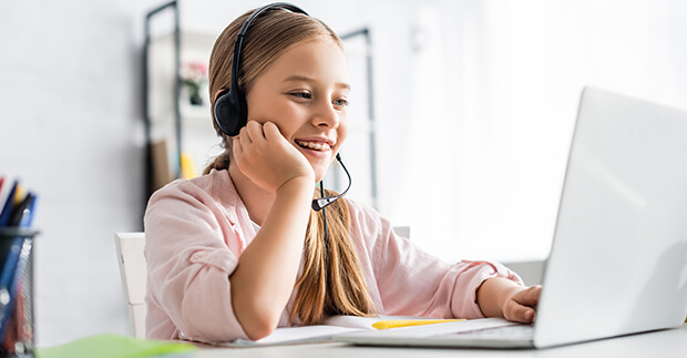 Girl with headphones at laptop
