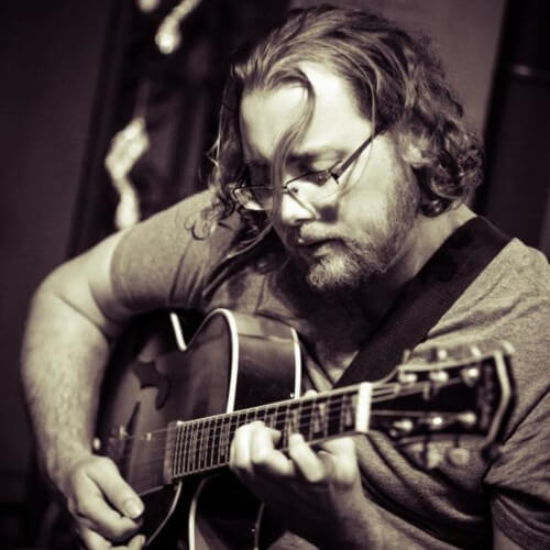 Daniel, coding teacher playing guitar