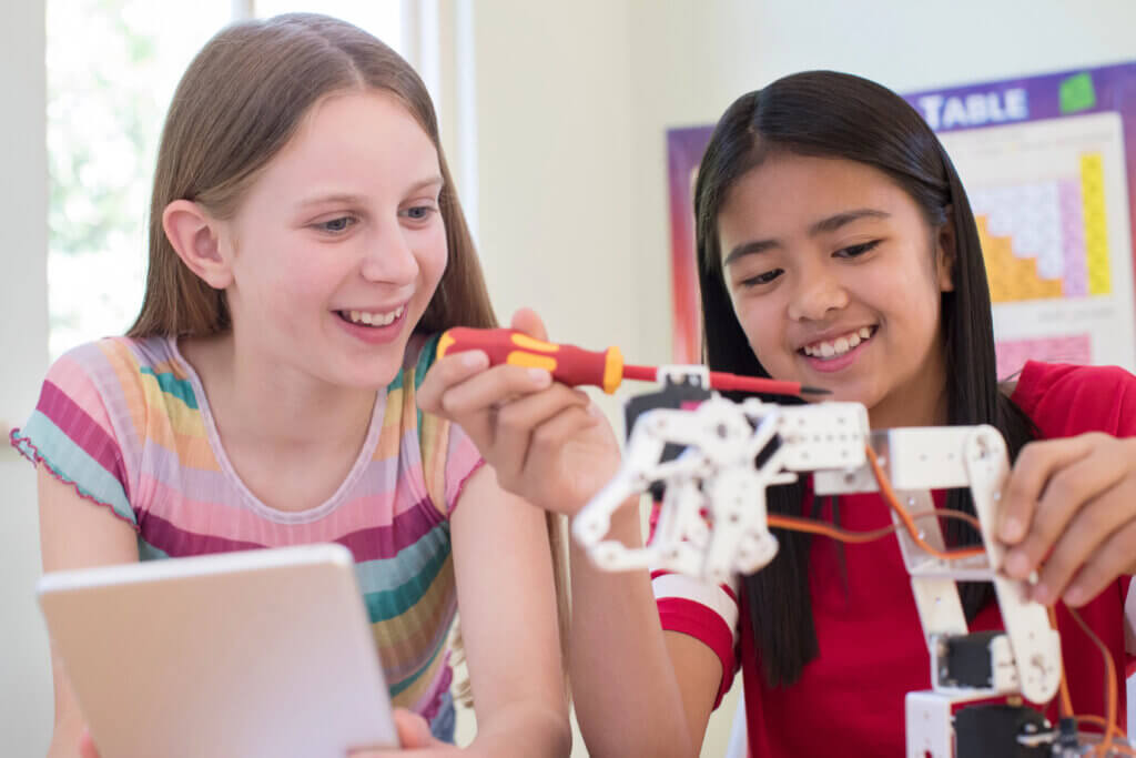 Girls working on a robot.