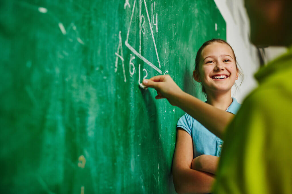 Girl at board with math problem