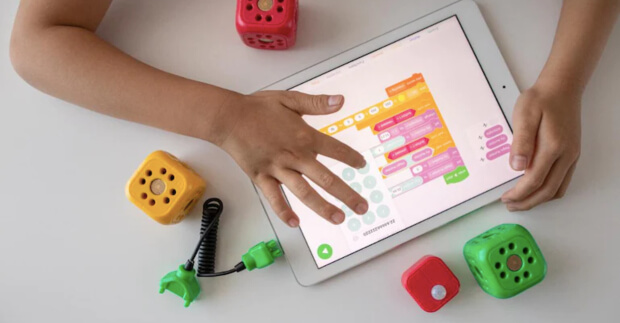 Kid on tablet with Scratch