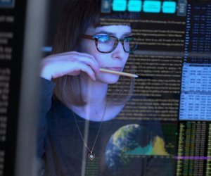 woman with glasses coding