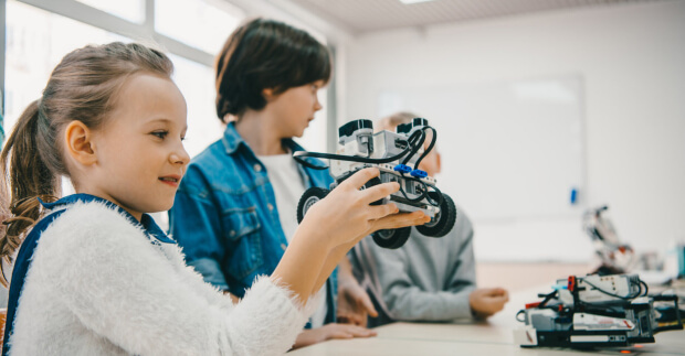 What is STEM, Girl holding robot in class